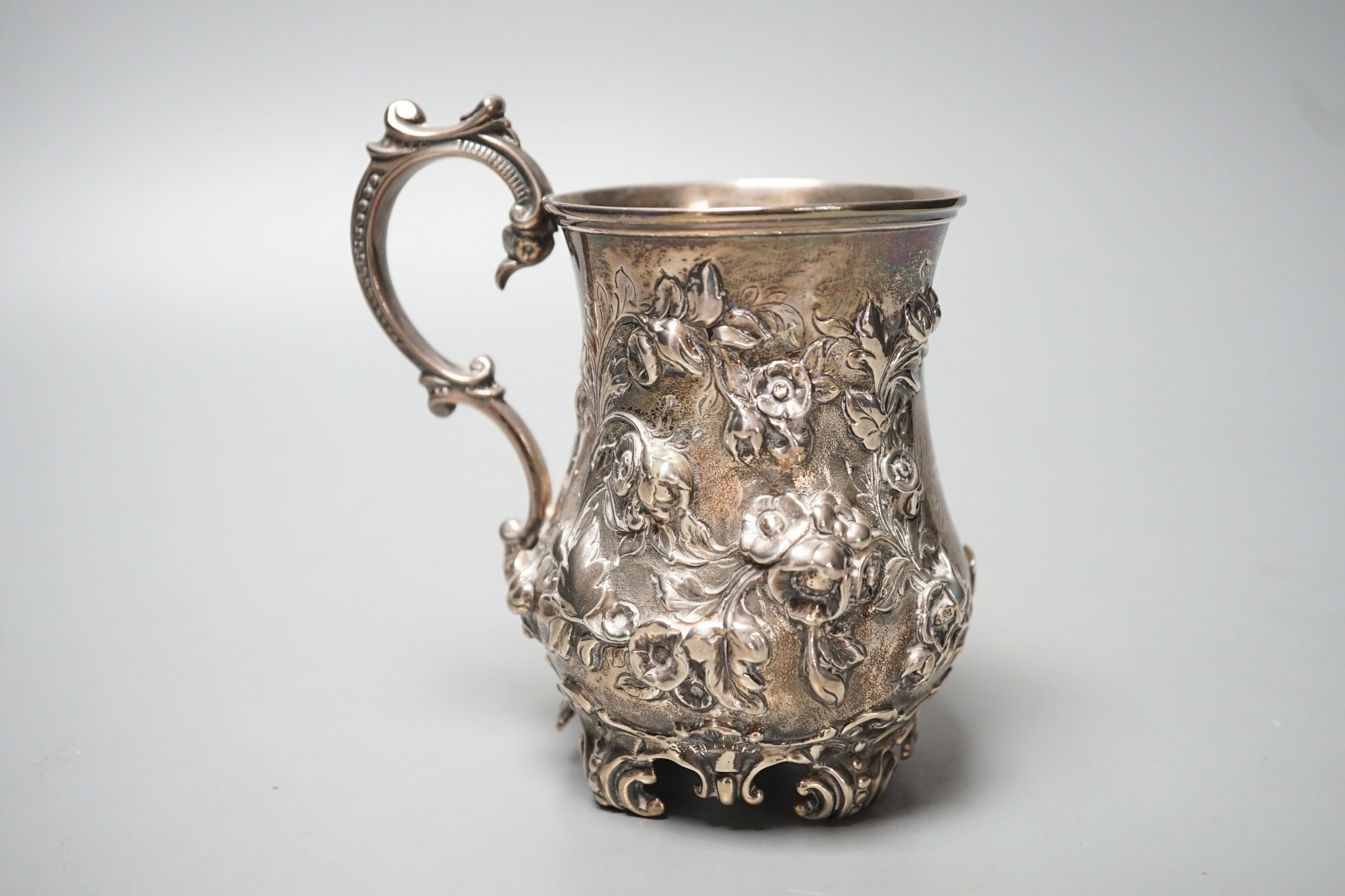 A Victorian embossed silver christening mug, Martin, Hall & Co, Sheffield, 1866, with engraved inscription, 12cm, 8oz.